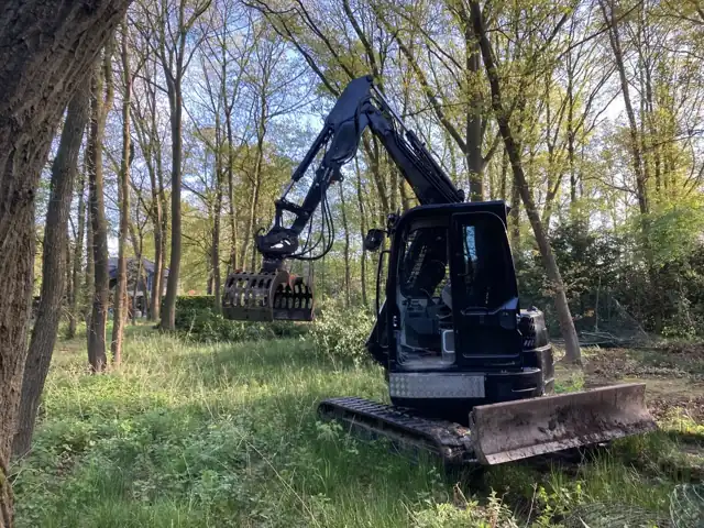 Rupskraan tussen de bomen tijdens grondwerken